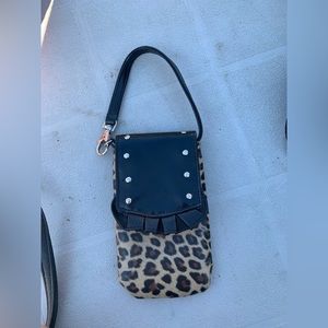Small leopard print cell phone holder/ purse. Top strap clips and un-clips.